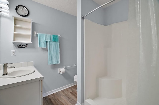 bathroom featuring a shower with curtain, vanity, toilet, and wood finished floors