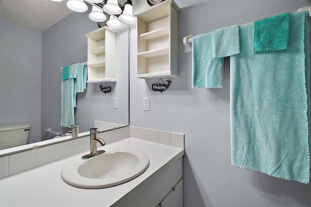 bathroom featuring toilet and vanity