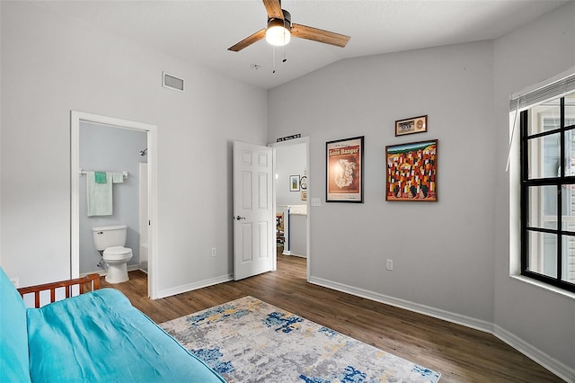 bedroom with visible vents, baseboards, lofted ceiling, and wood finished floors