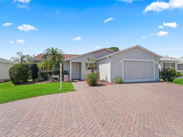 ranch-style house with a garage, decorative driveway, and a front yard
