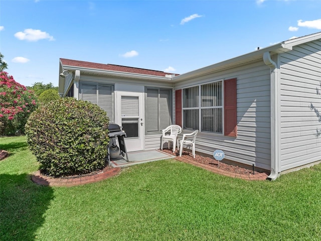 back of property featuring a lawn
