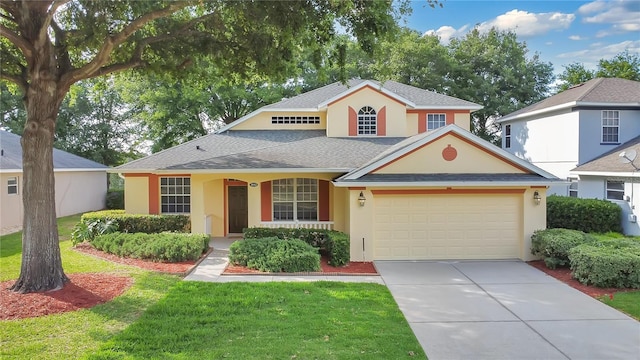 traditional-style house with concrete driveway, stucco siding, a front lawn, and a garage