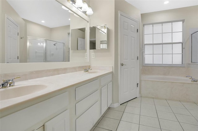 bathroom with double vanity, a garden tub, a stall shower, a sink, and tile patterned floors