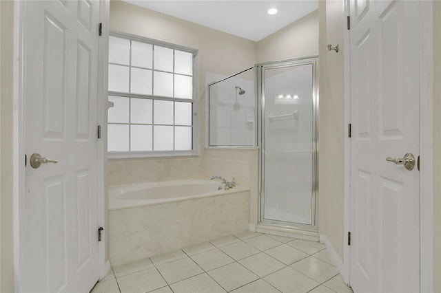 bathroom with a garden tub, tile patterned flooring, and a stall shower