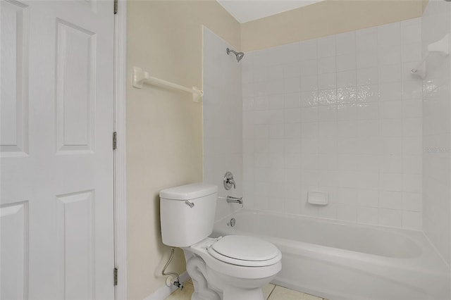 bathroom with bathing tub / shower combination, toilet, baseboards, and tile patterned floors