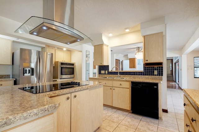 kitchen featuring light brown cabinets, light countertops, island exhaust hood, a sink, and black appliances