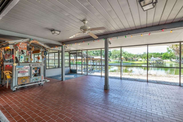 interior space featuring a water view and a ceiling fan