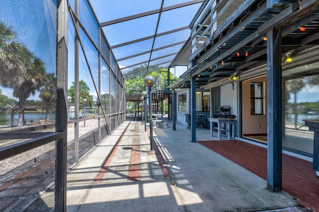 unfurnished sunroom with a water view and a wealth of natural light