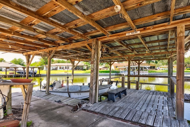 dock area with boat lift and a water view