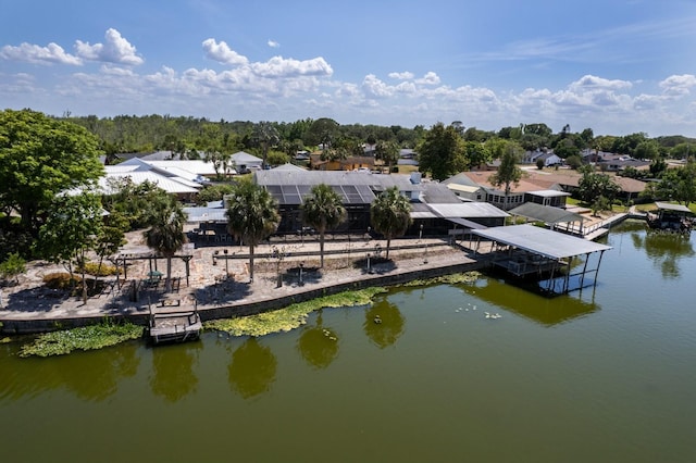 birds eye view of property with a water view and a residential view