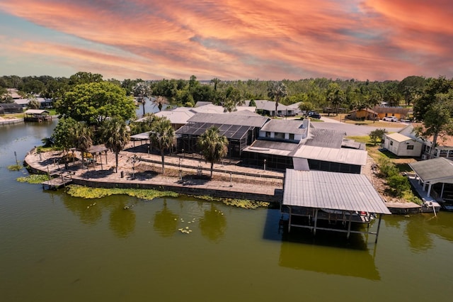 dock area with a water view, fence, boat lift, and a residential view