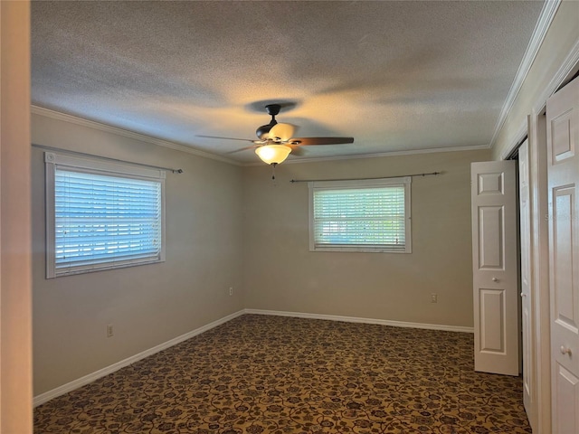 unfurnished bedroom featuring crown molding, multiple windows, a textured ceiling, and ceiling fan
