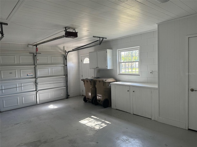 garage featuring wooden ceiling and a garage door opener