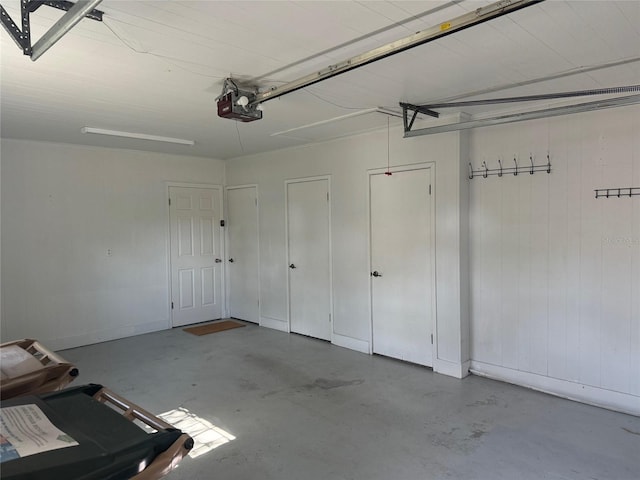 garage with baseboards and a garage door opener