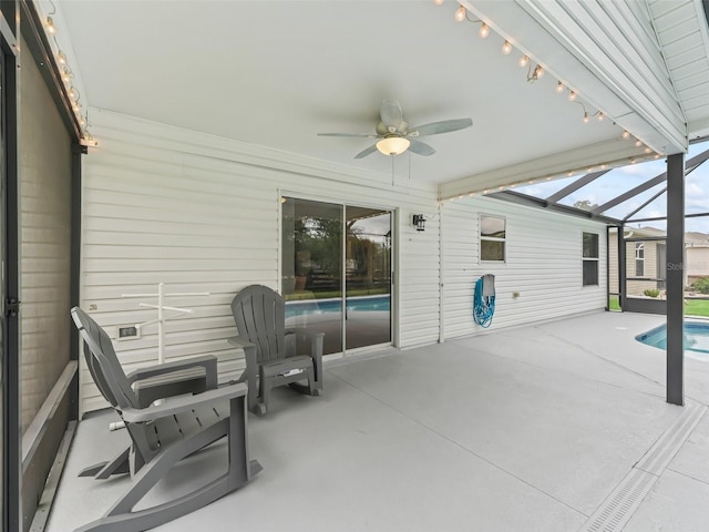 view of patio with ceiling fan, a lanai, and an outdoor pool