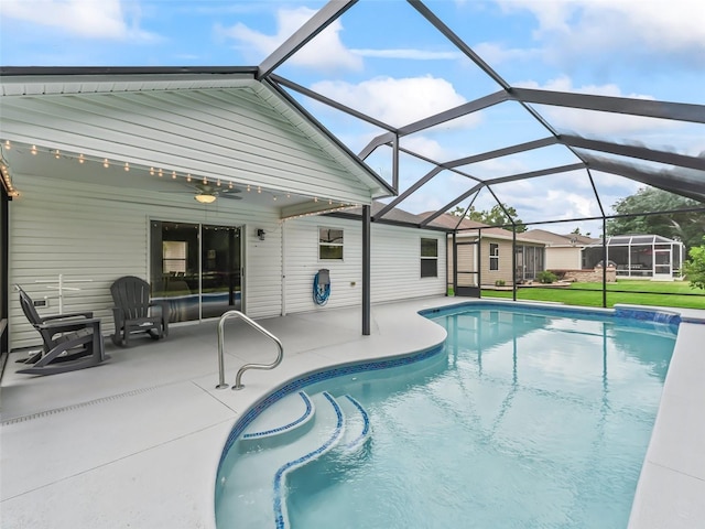 outdoor pool featuring a yard, ceiling fan, a patio area, and glass enclosure