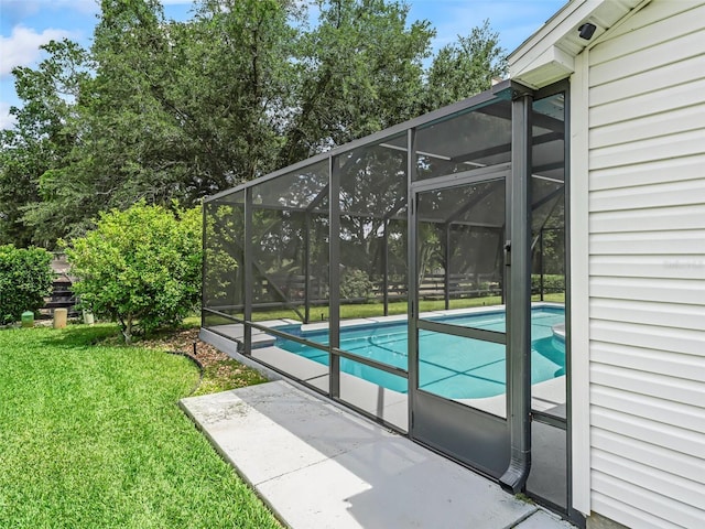 pool featuring a lawn, a lanai, and a patio area