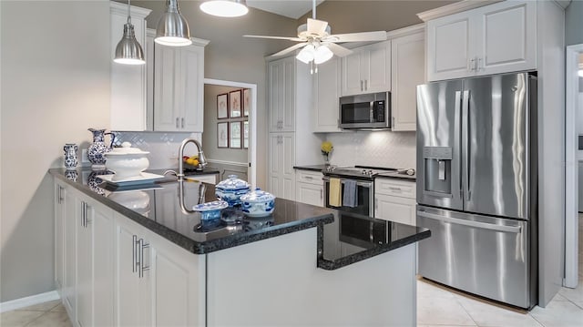 kitchen with white cabinets, stainless steel appliances, a ceiling fan, and tasteful backsplash
