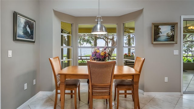 dining area with baseboards and light tile patterned floors