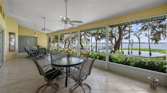 sunroom / solarium with outdoor dining area, a water view, and ceiling fan