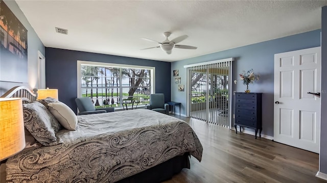 bedroom featuring a ceiling fan, access to exterior, visible vents, wood finished floors, and baseboards