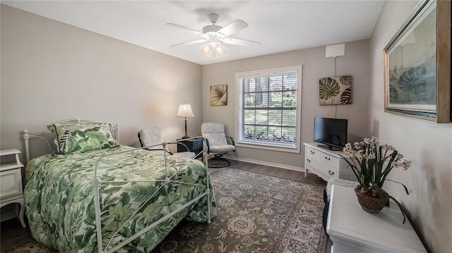 bedroom featuring baseboards, ceiling fan, and wood finished floors