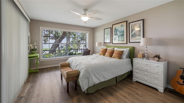 bedroom featuring baseboards, a ceiling fan, and wood finished floors