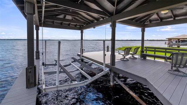 view of dock featuring boat lift and a water view