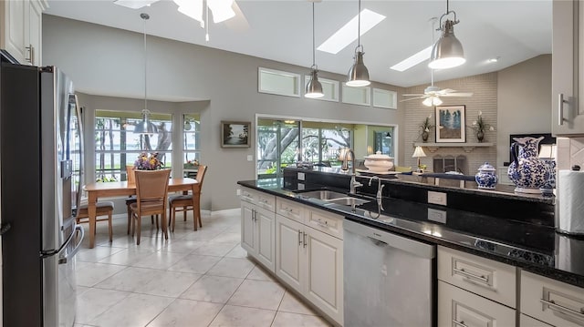 12104 Elbert St, Clermont, FL 34711 - kitchen with appliances with stainless steel finishes, ceiling fan, light tile patterned floors, pendant lighting, and white cabinetry