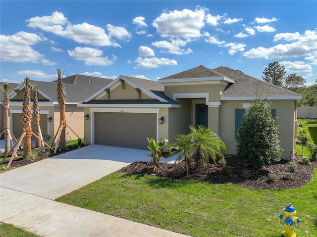 view of front of home featuring stucco siding, a garage, roof with shingles, a front yard, and concrete driveway