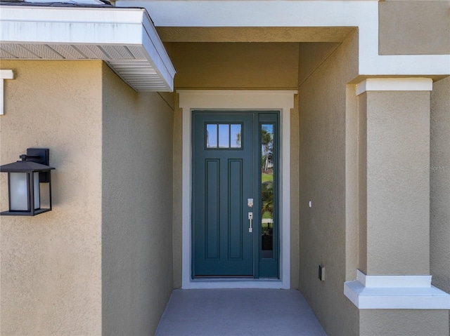 entrance to property with stucco siding