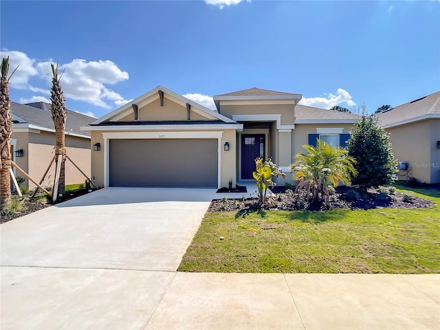view of front of house featuring stucco siding, an attached garage, concrete driveway, and a front lawn