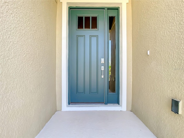 property entrance featuring stucco siding