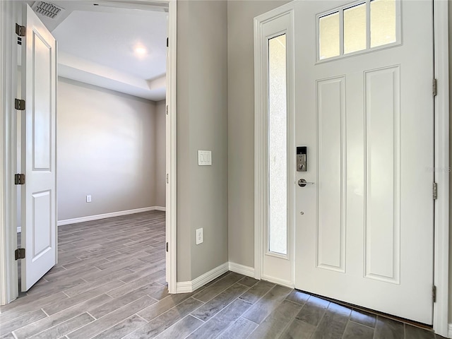 foyer featuring wood finished floors and baseboards