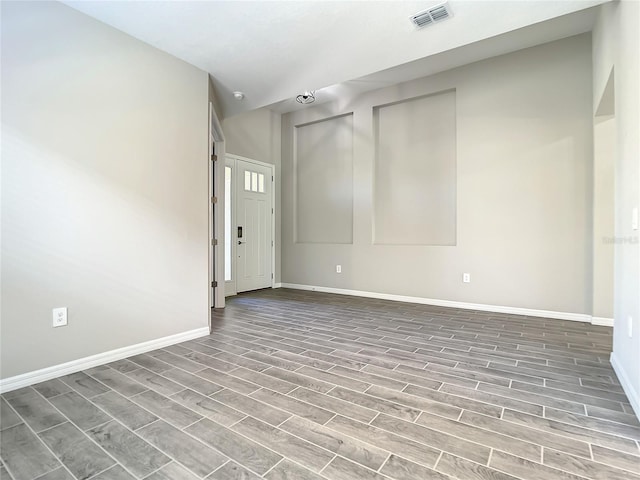 empty room featuring wood finish floors and baseboards