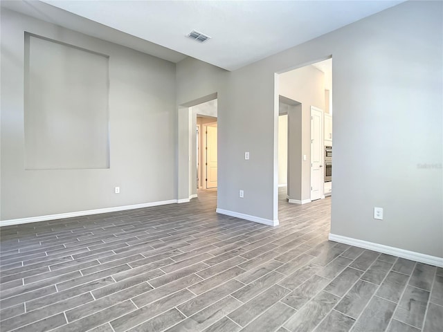 unfurnished room featuring wood finished floors and baseboards