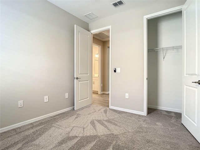 unfurnished bedroom featuring carpet flooring, a closet, and baseboards