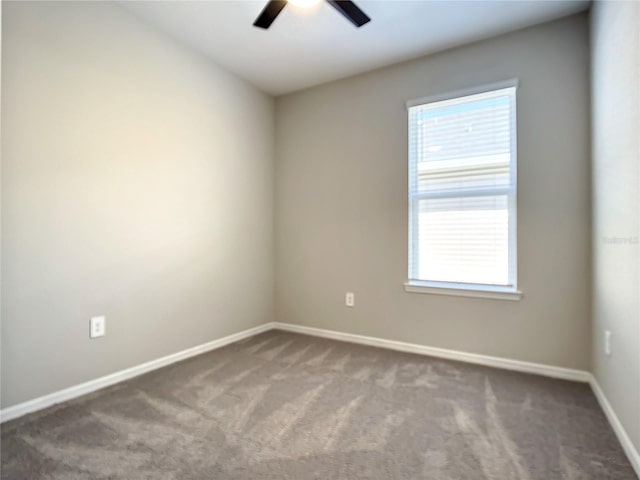 unfurnished room featuring ceiling fan, carpet, and healthy amount of natural light