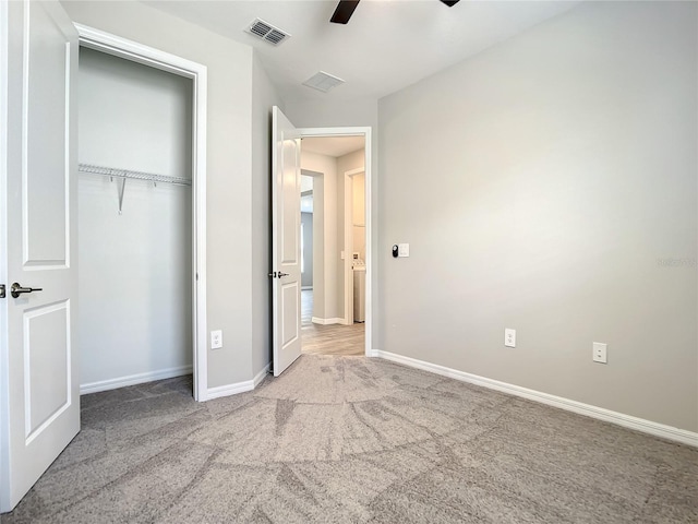 unfurnished bedroom with carpet flooring, baseboards, a closet, and ceiling fan