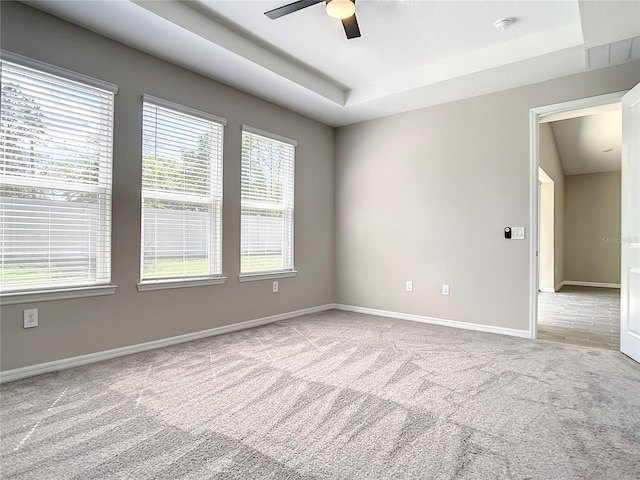 empty room featuring ceiling fan, carpet flooring, healthy amount of natural light, and baseboards