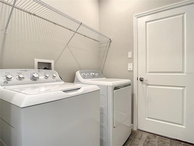 laundry area featuring washer and clothes dryer and wood finished floors