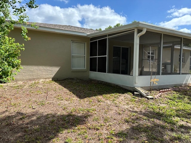 4046 E Bennett St, Inverness, FL 34453 - view of side of property featuring a sunroom and stucco siding
