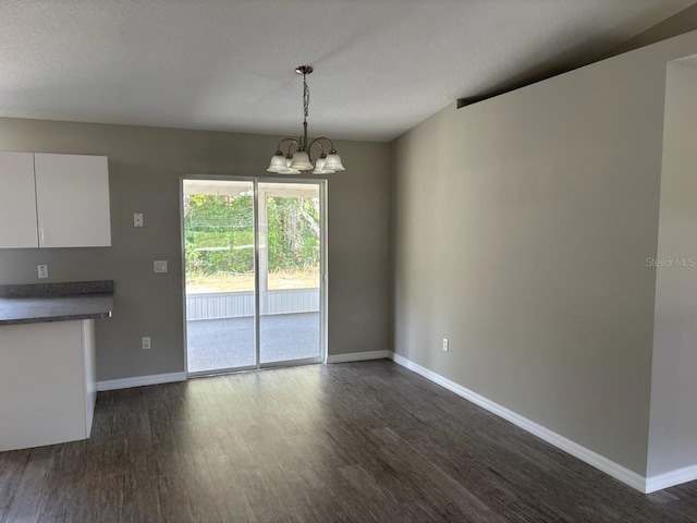4046 E Bennett St, Inverness, FL 34453 - unfurnished dining area featuring baseboards, dark wood-style flooring, and a notable chandelier