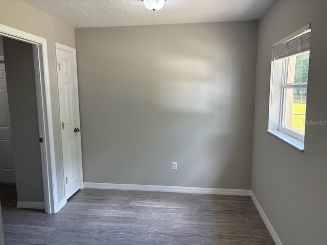 4046 E Bennett St, Inverness, FL 34453 - empty room with baseboards, a textured ceiling, and wood finished floors