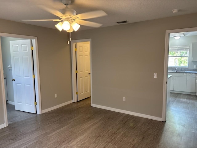 4046 E Bennett St, Inverness, FL 34453 - interior space featuring a sink, a ceiling fan, baseboards, wood finished floors, and visible vents