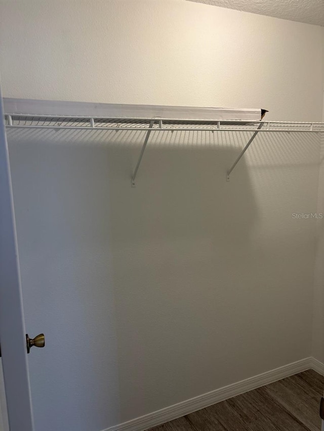 4046 E Bennett St, Inverness, FL 34453 - walk in closet with dark wood finished floors