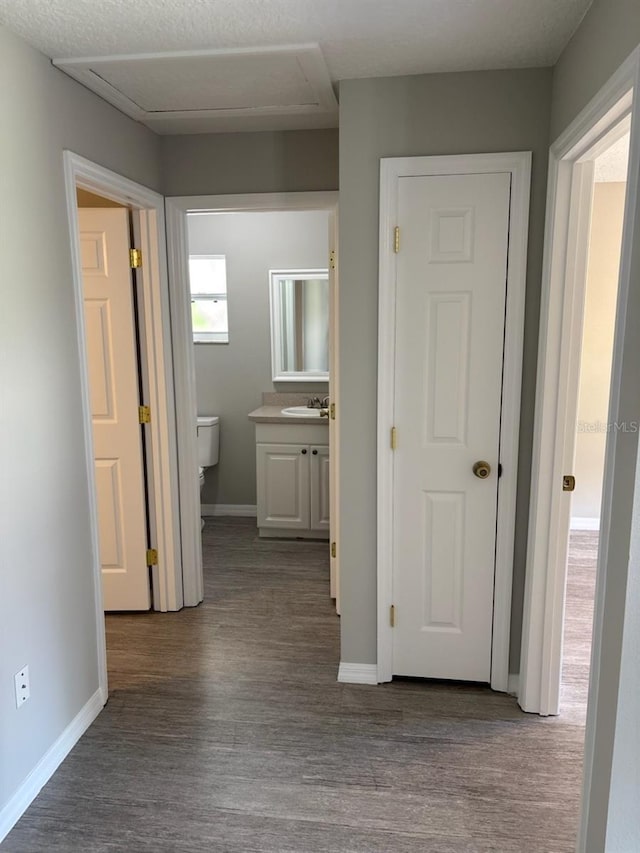 4046 E Bennett St, Inverness, FL 34453 - corridor featuring baseboards, attic access, and wood finished floors