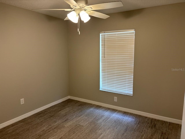 4046 E Bennett St, Inverness, FL 34453 - unfurnished room featuring a textured ceiling, ceiling fan, baseboards, and dark wood-type flooring