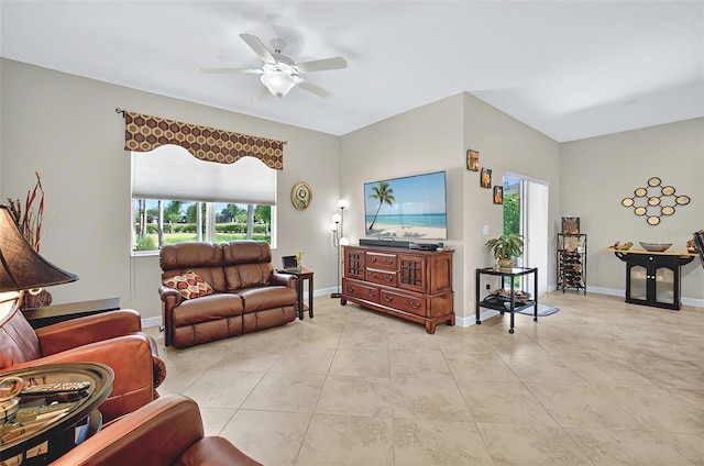 living room with light tile patterned floors, baseboards, and ceiling fan