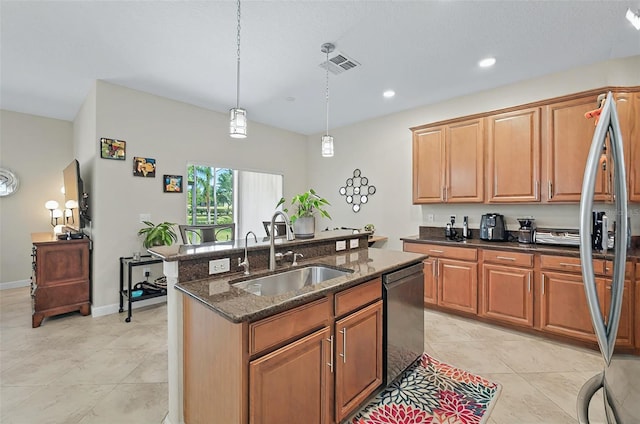 kitchen with a sink, dark stone counters, a center island with sink, visible vents, and dishwasher